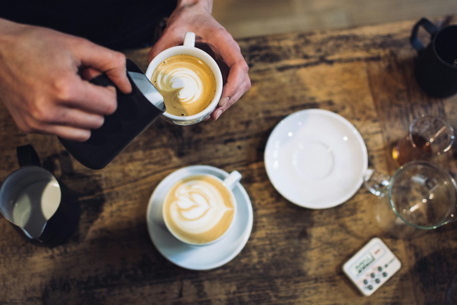 A barista serving customers at a cafe counter
