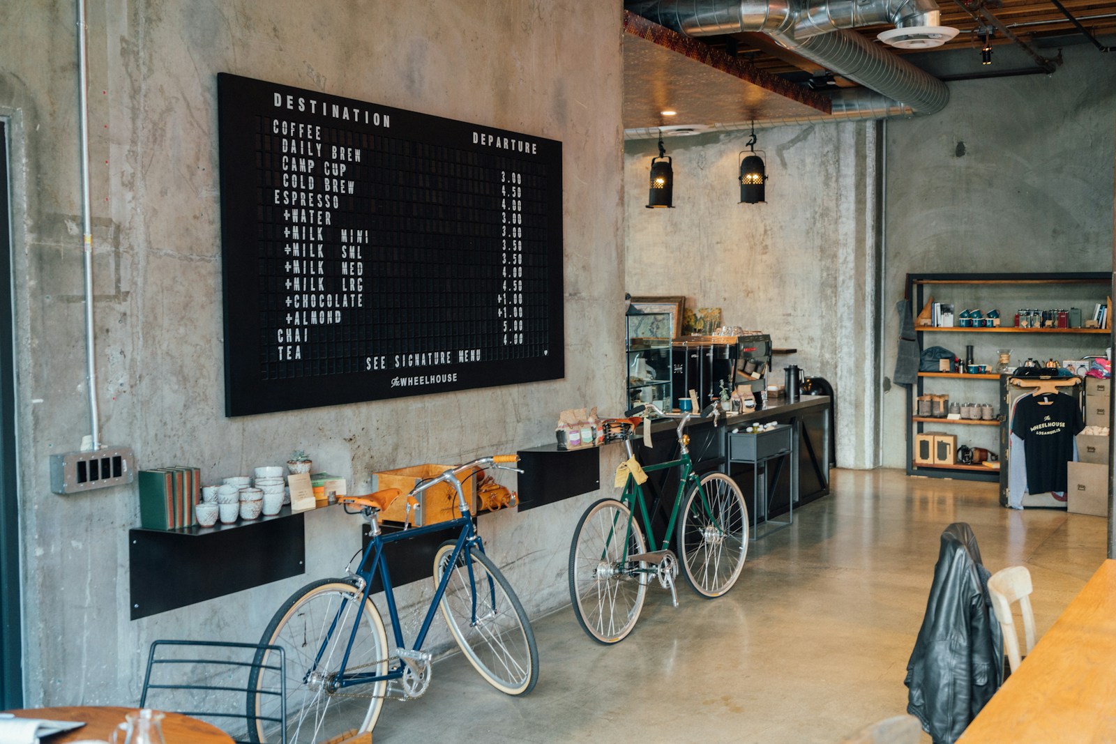 A beautifully designed cafe interior with tasteful decor and a creative menu board